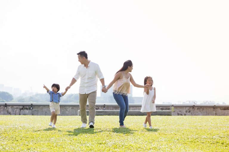 family holding hands while outdoor